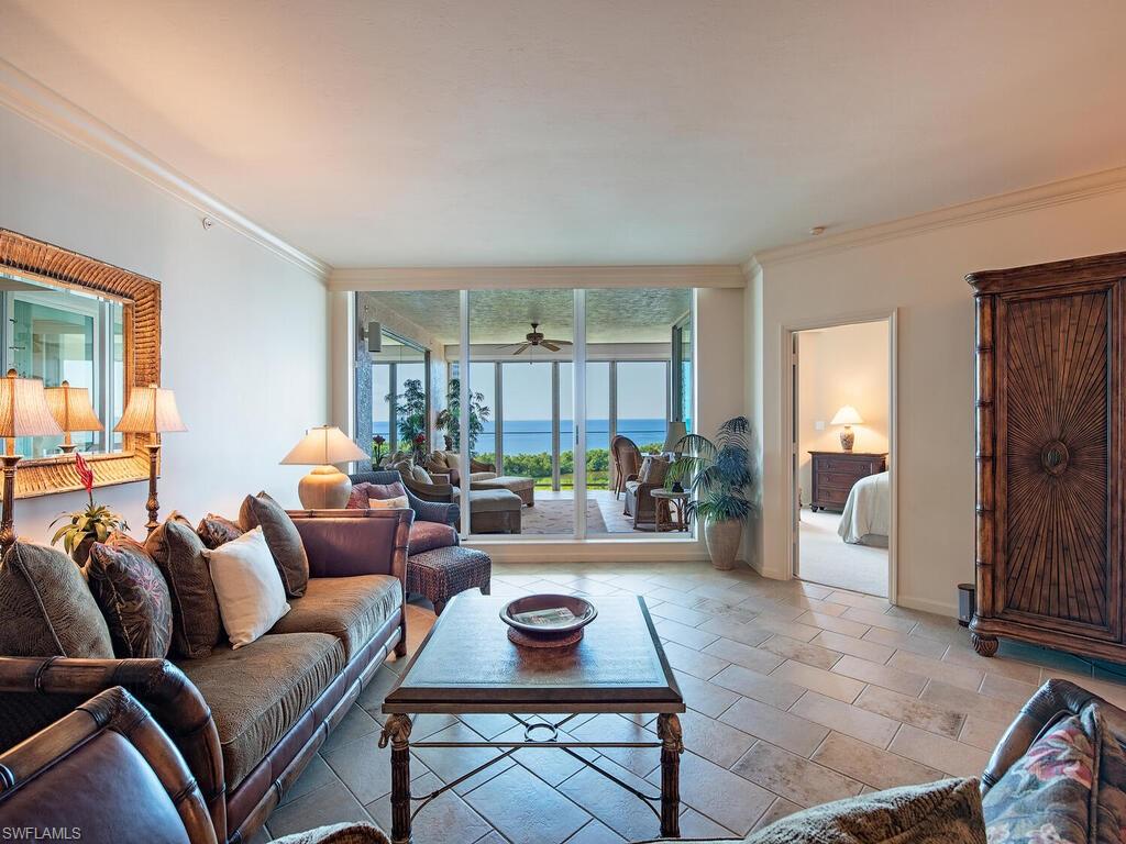 60 Seagate Drive, Unit 904 Naples, FL 34103 - Photo 7 of 35 a living room with furniture and a window