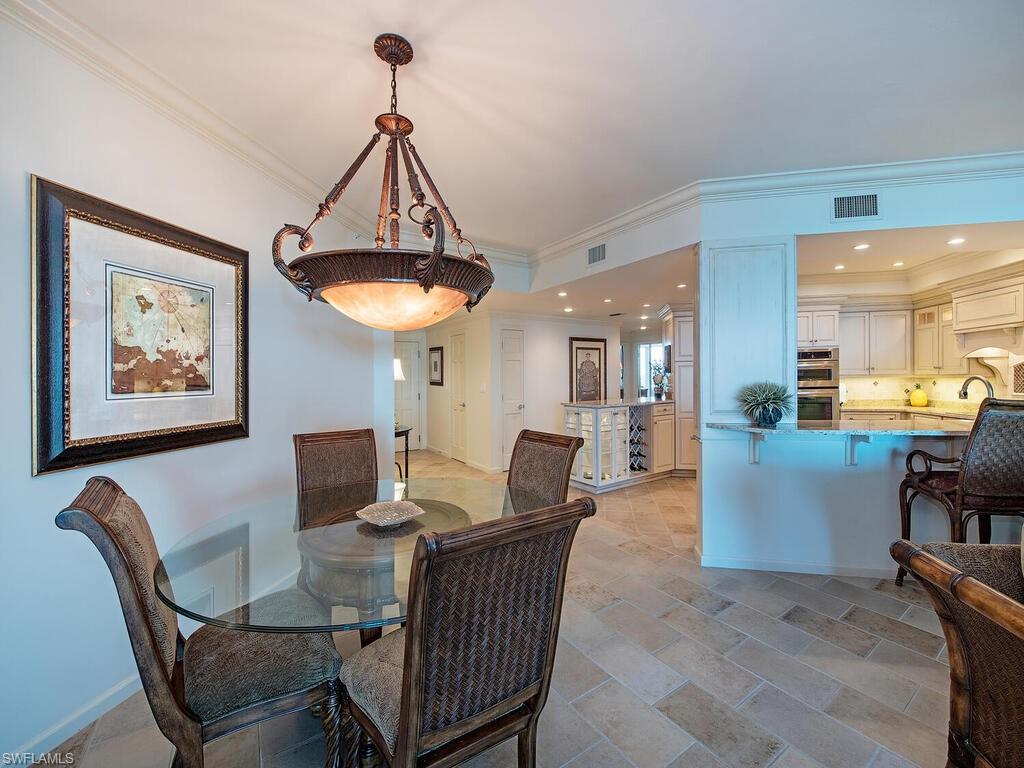 60 Seagate Drive, Unit 904 Naples, FL 34103 - Photo 9 of 35 a dining room with furniture and window