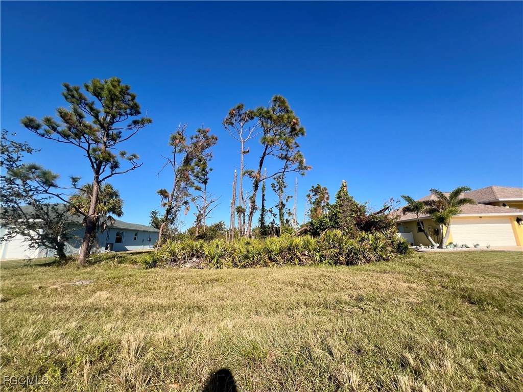 84 Fairway Road Rotonda West, FL 33947 - Photo 1 of 4 a view of a yard with a tree
