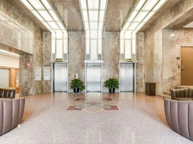 a view of a lobby with furniture and a potted plant