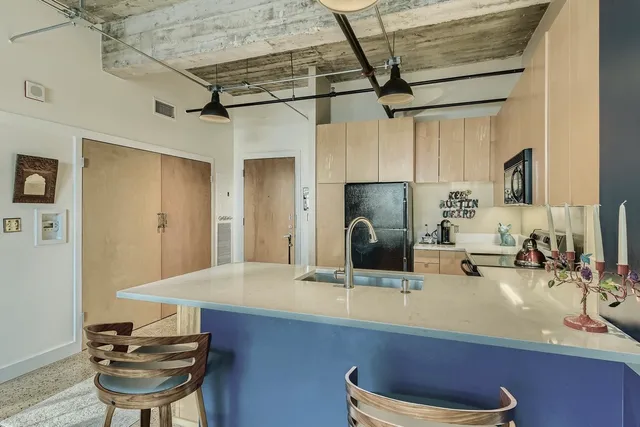 a kitchen with a sink cabinets and appliances