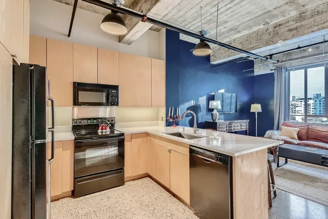 a kitchen with a sink appliances and cabinets