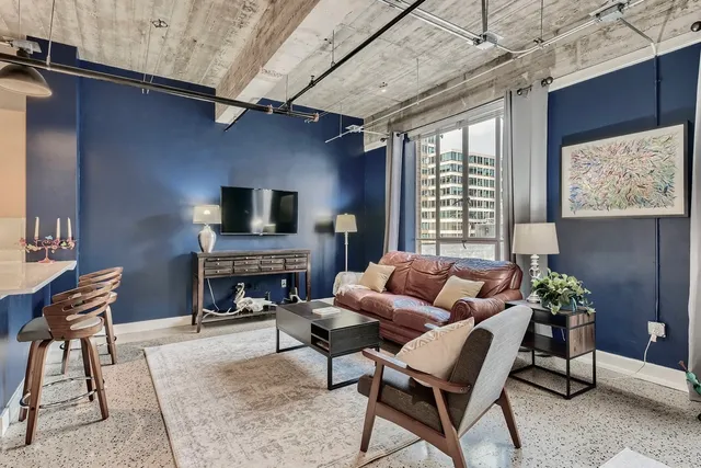 a living room with furniture a fireplace and a flat screen tv