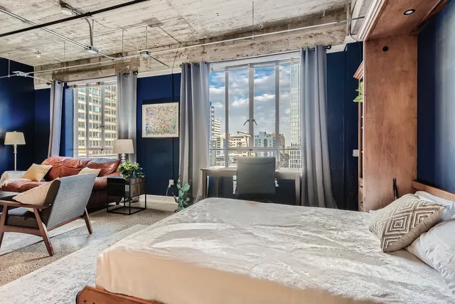 a bedroom with a bed and wooden floor