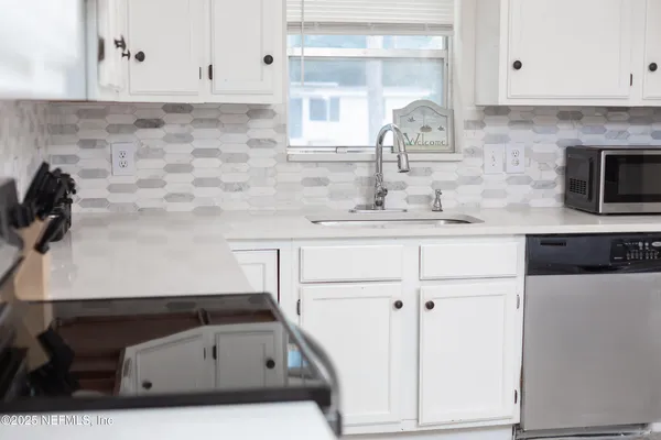 a kitchen with a sink and cabinets