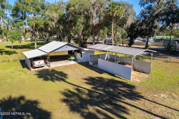 an aerial view of a house with a yard