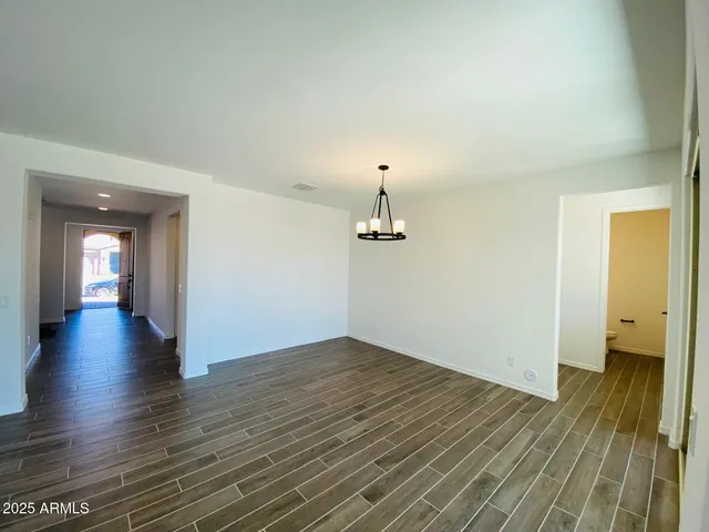 a kitchen with kitchen island granite countertop a sink and refrigerator