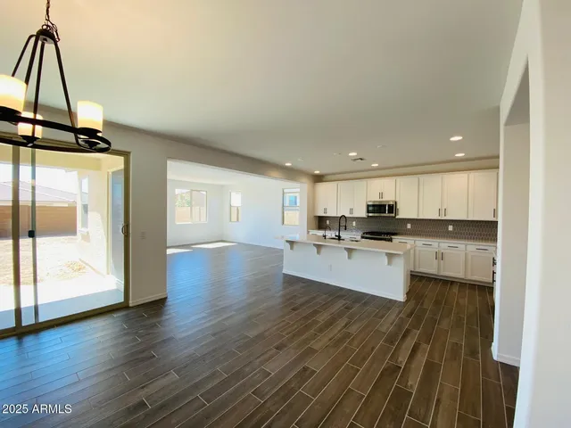 a large white kitchen with a large window