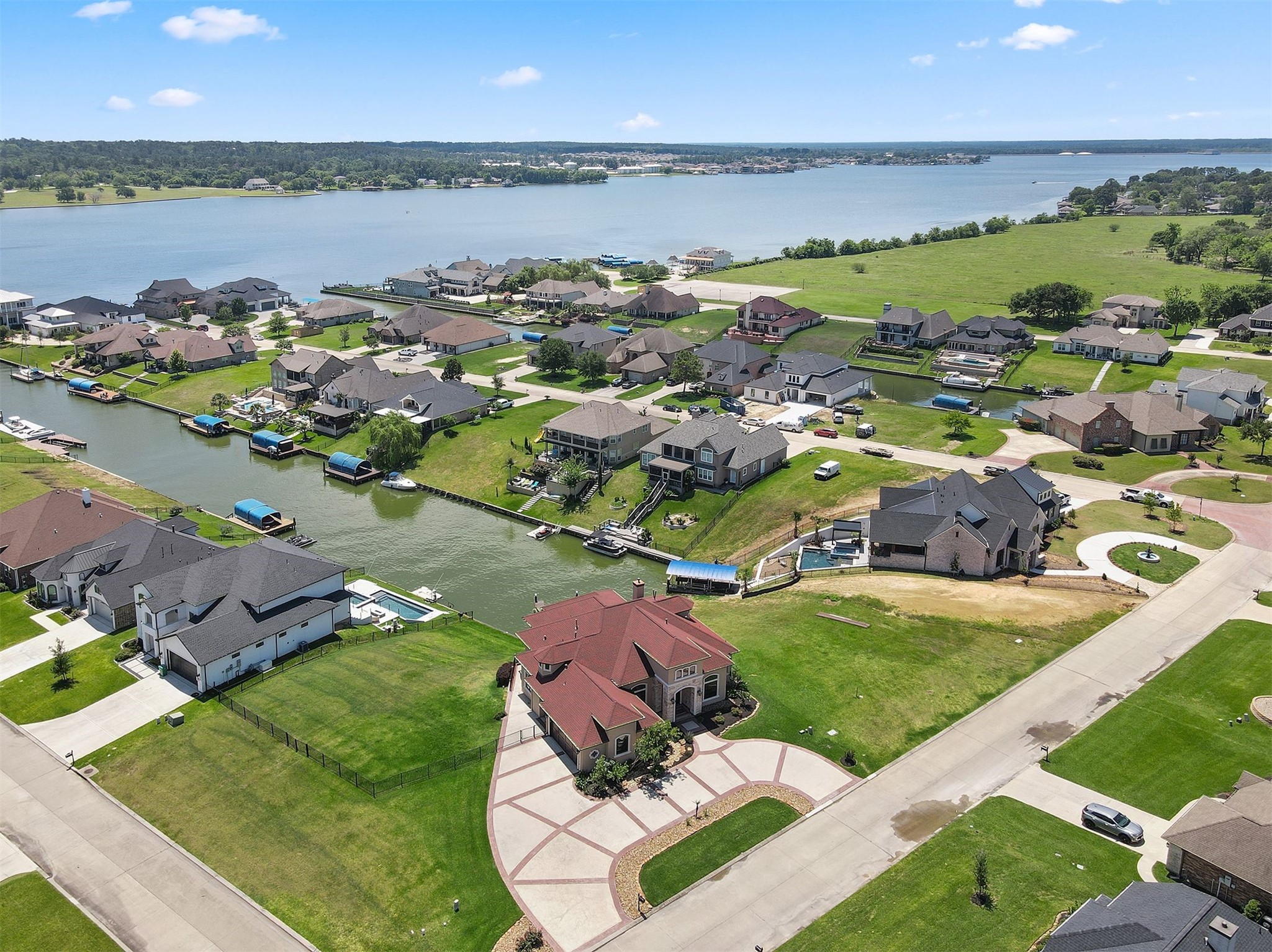 10896 Decatur Street Willis, TX 77318 - Photo 4 of 50 Nestled in a serene lakeside neighborhood, this aerial view reveals spacious homes with private docks, well-maintained yards, and breathtaking waterfront vistas, perfect for tranquil living.
