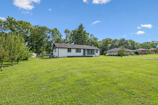 a front view of house with yard and green space