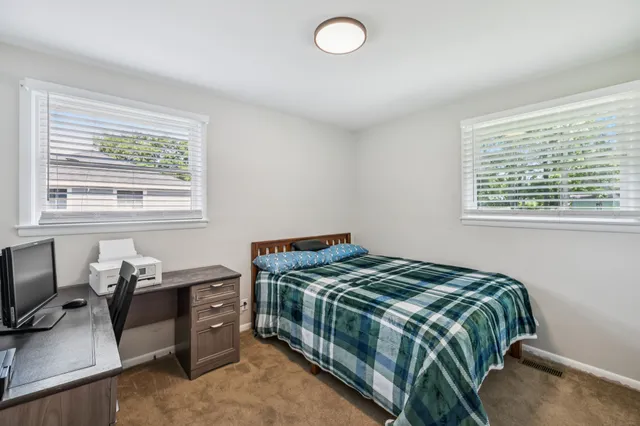 a bedroom with a bed and a window