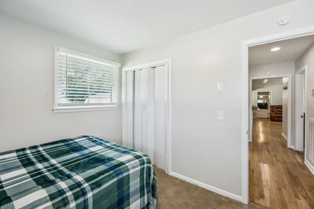 a bedroom with a bed and a chair