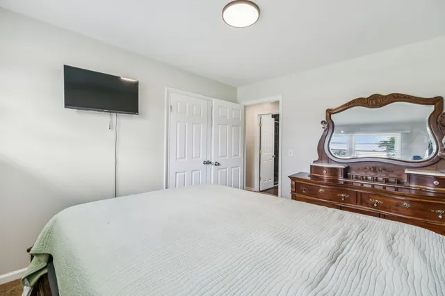 a bedroom with a bed and window