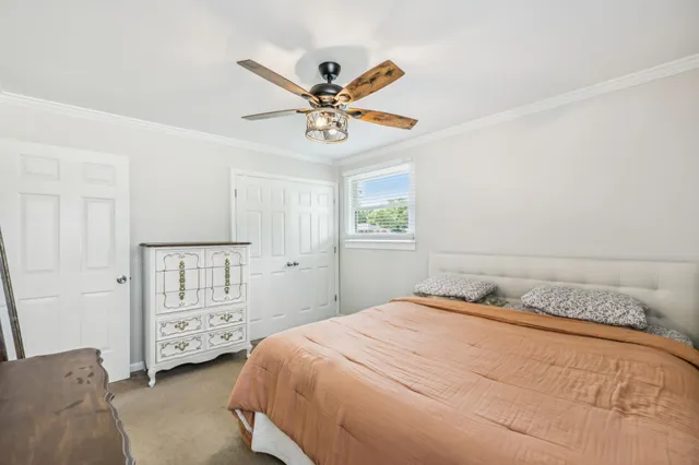 a bathroom with a granite countertop sink vanity mirror and toilet