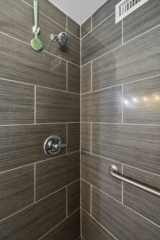 a large living room with kitchen view and a couch