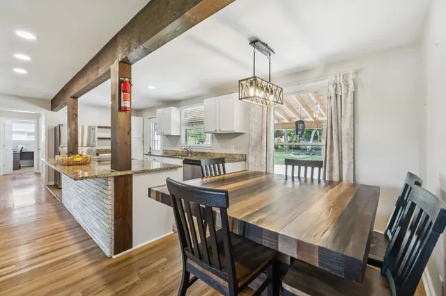 a large kitchen with kitchen island granite countertop a large counter top and wooden floor