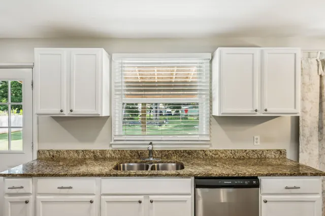 a bedroom with a bed and a mirror