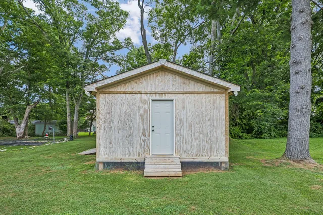 a view of a house with patio and a yard