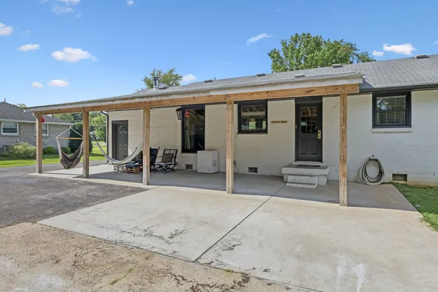 a view of a patio with table and chairs