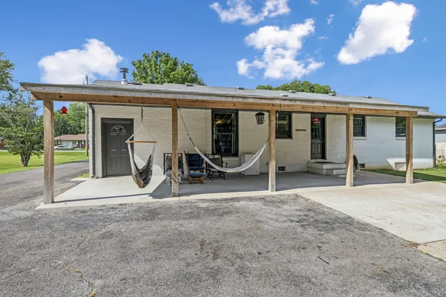 a front view of a house with a garden and patio