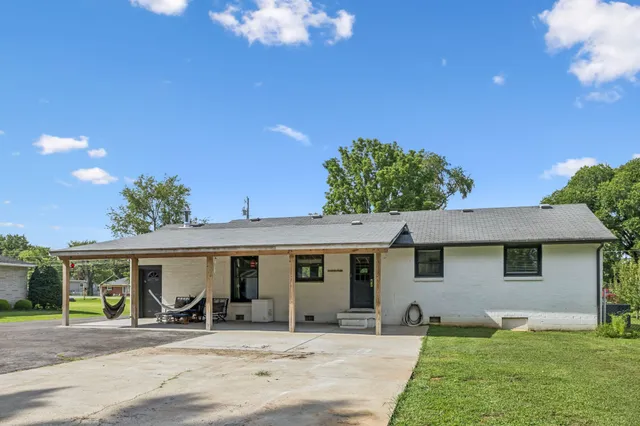 a view of house with outdoor space and sitting area