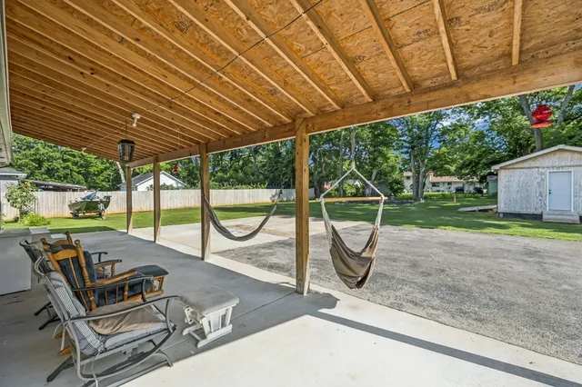 a view of a green field with wooden fence