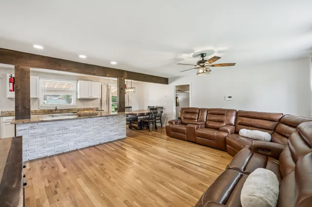 a living room with furniture and a wooden floor