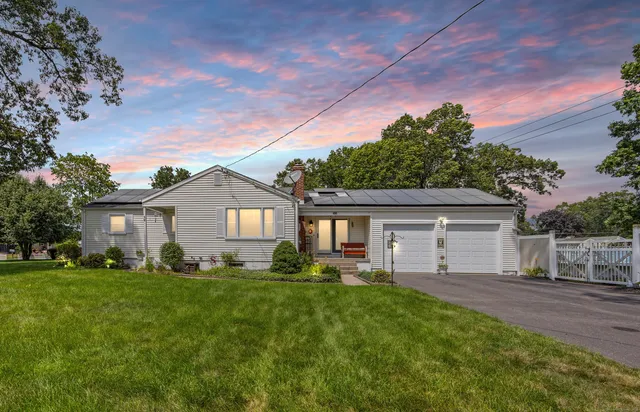 a front view of house with yard and green space