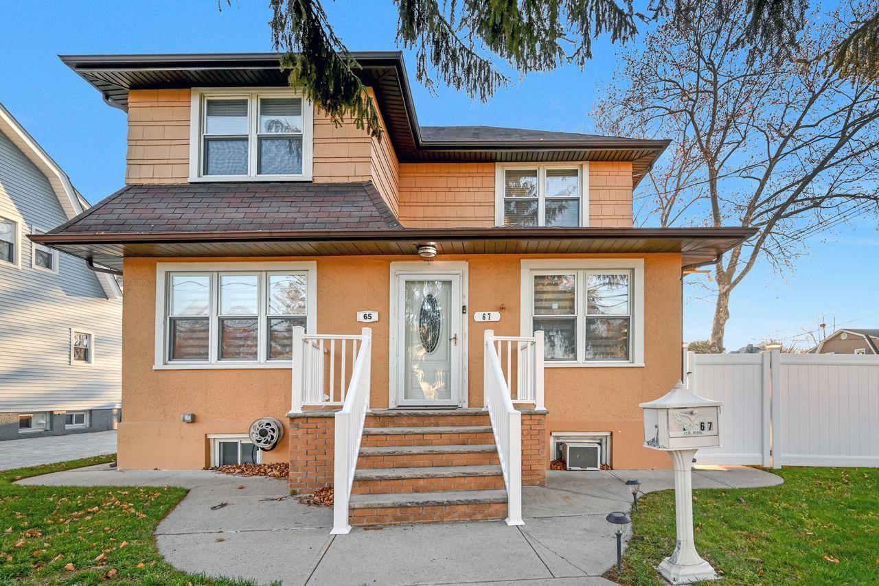 a front view of a house with a garden and plants