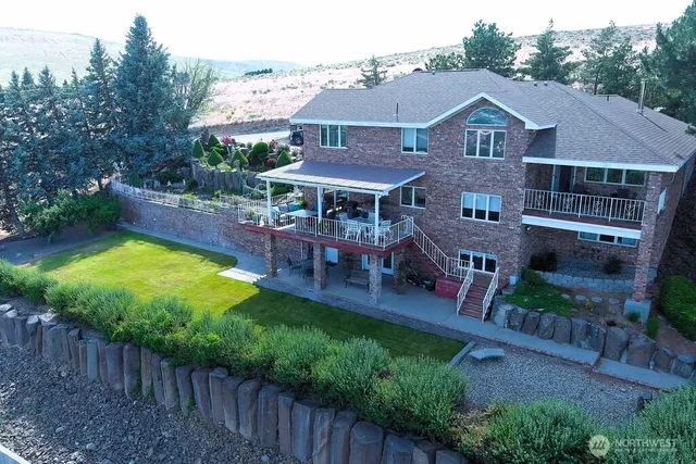 a aerial view of a house with swimming pool garden and patio