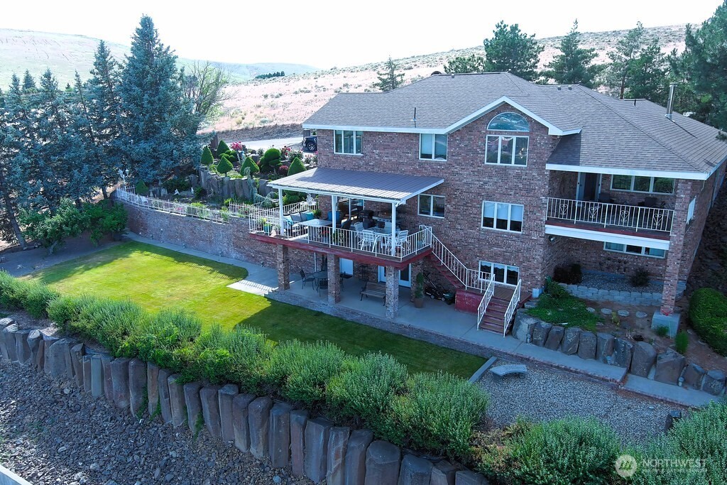 a aerial view of a house with swimming pool garden and patio