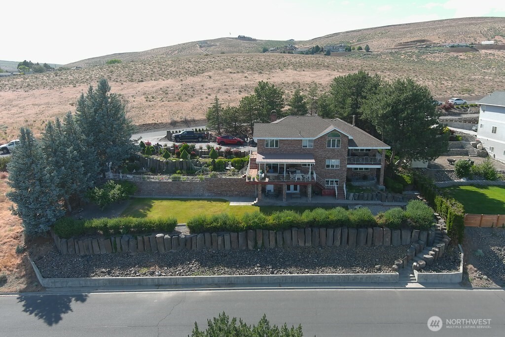 440 West Line Road Ephrata, WA 98823 - Photo 3 of 31 a view of a house next to a lake with a mountain