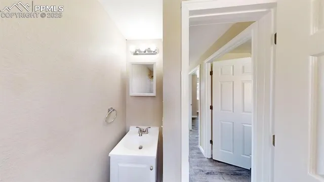a bathroom with a sink and mirror with toilet