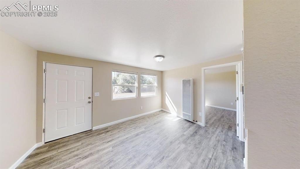 2405 East St Vrain Street Colorado Springs, CO 80909 - Photo 17 of 32 an empty room with wooden floor and windows