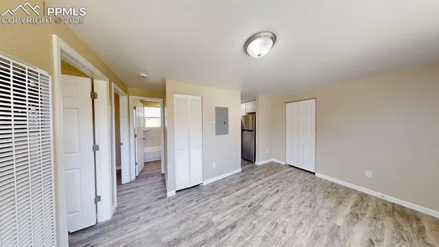 a view of hallway with wooden floor