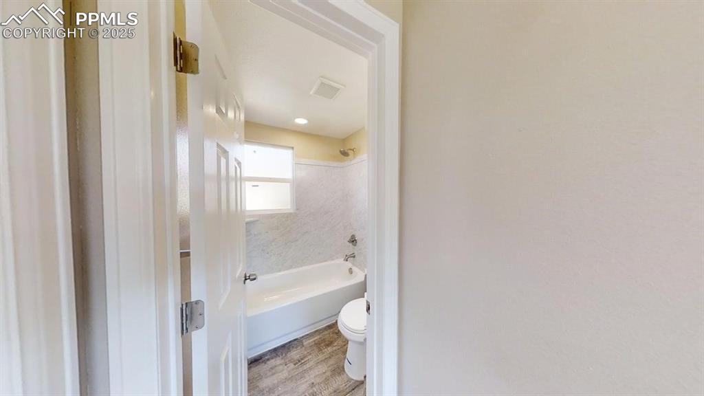 2405 East St Vrain Street Colorado Springs, CO 80909 - Photo 19 of 32 a bathroom with a bathtub and a shower