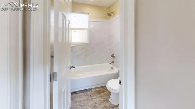 a bathroom with a toilet a sink and bathtub