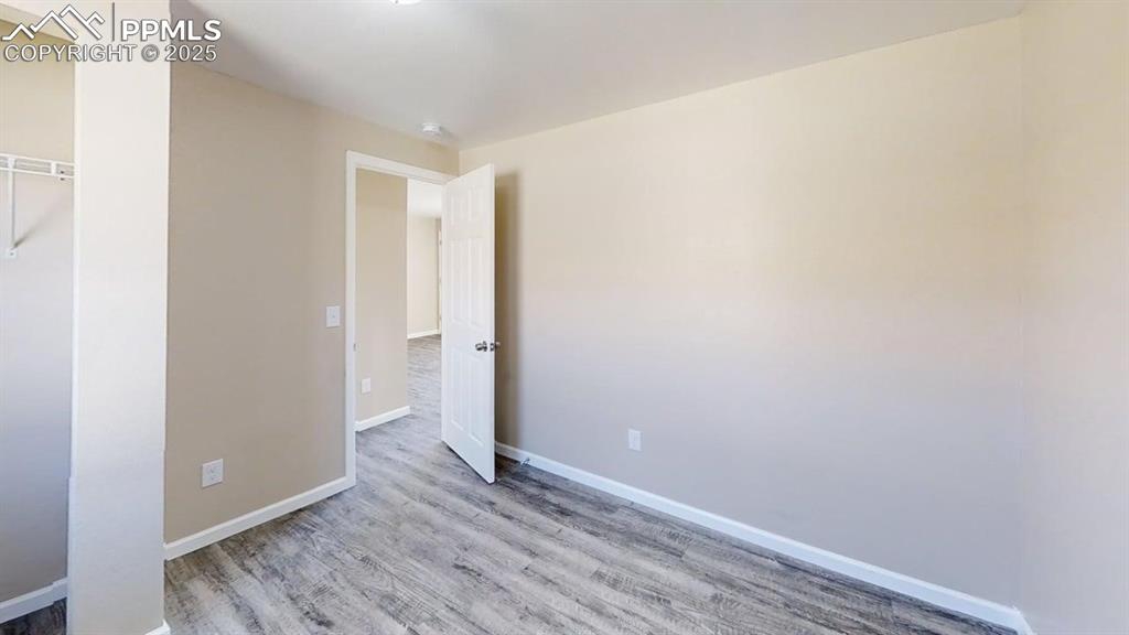 2405 East St Vrain Street Colorado Springs, CO 80909 - Photo 25 of 32 a view of an empty room with wooden floor