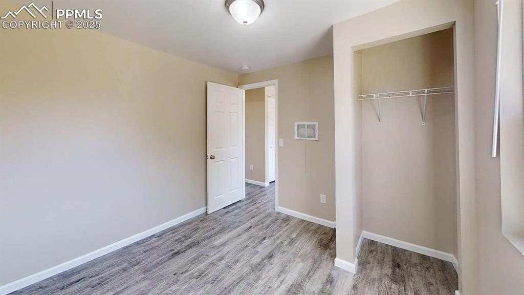 2405 East St Vrain Street Colorado Springs, CO 80909 - Photo 28 of 32 a view of an empty room with wooden floor
