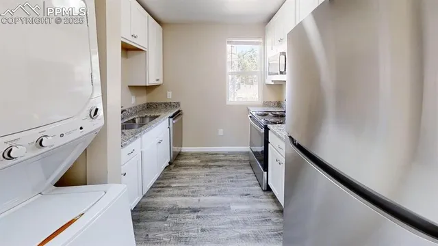 a kitchen with granite countertop a refrigerator and a stove