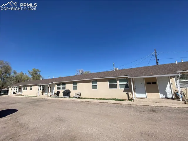 a front view of a house with a road