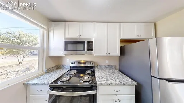 a kitchen with a stove and a refrigerator