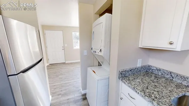 a kitchen with a refrigerator and cabinets