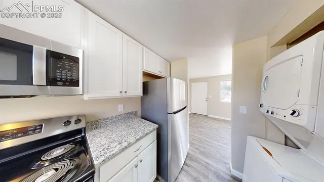 a kitchen with stainless steel appliances granite countertop a stove and a refrigerator