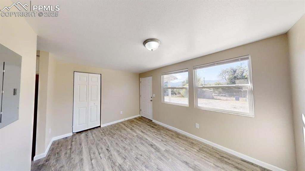 2405 East St Vrain Street Colorado Springs, CO 80909 - Photo 10 of 32 a view of an empty room with wooden floor and a window