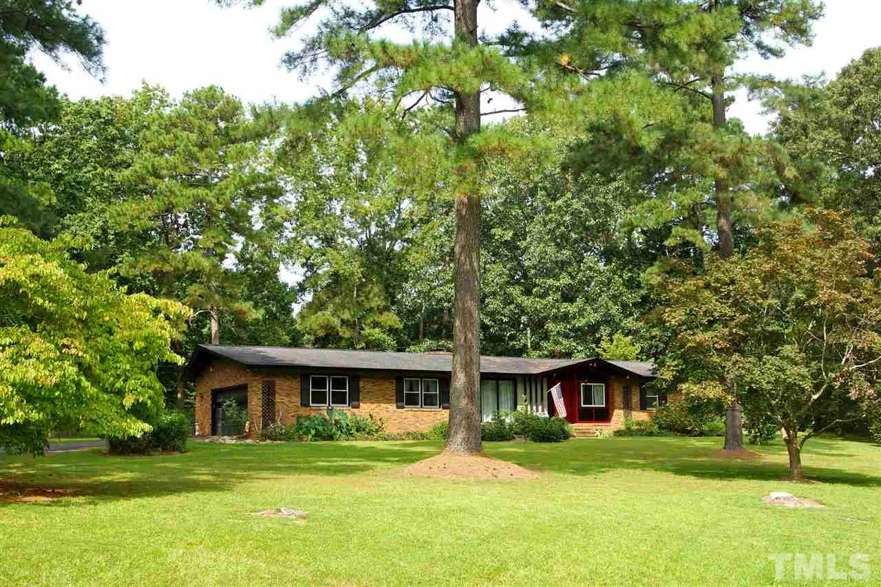9449 Ferrell Road Zebulon, NC 27597 - Photo 2 of 28 Your new home is surround with beautiful trees.