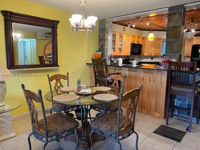 a view of a dining room with furniture and a chandelier