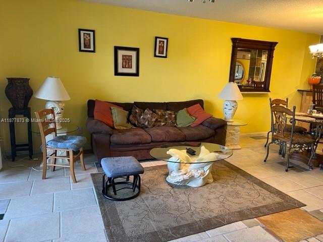 600 Uno Lago Drive, Unit 302 Juno Beach, FL 33408 - Photo 4 of 11 a living room with furniture and a couch