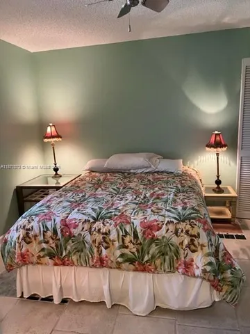 a bedroom with a bed and a lamp