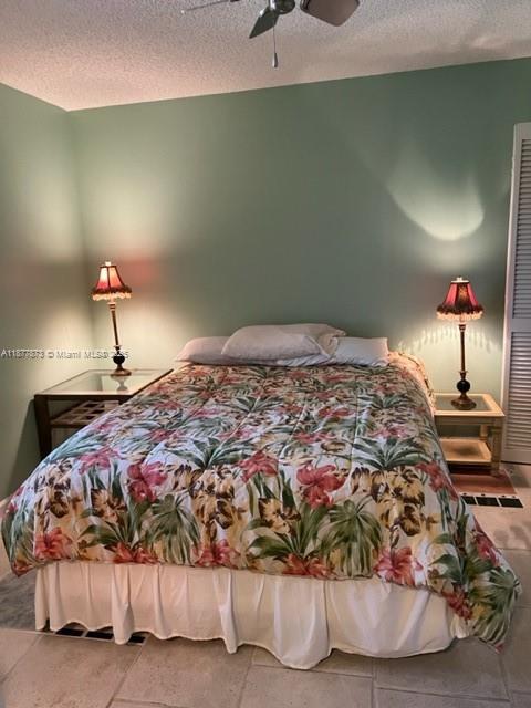 600 Uno Lago Drive, Unit 302 Juno Beach, FL 33408 - Photo 9 of 11 a bedroom with a bed and a lamp